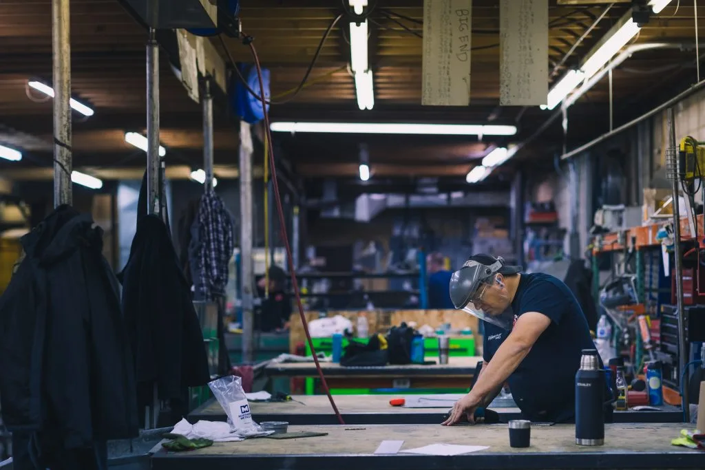 LSM tradesperson working at a bench in the sheet metal fabrication shop